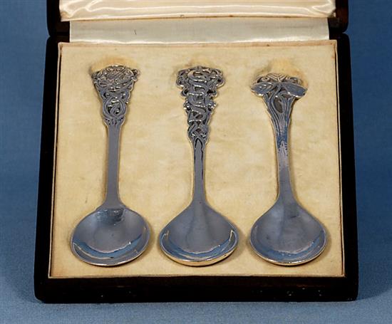 A rare cased set of three George V Arts & Crafts silver spoons, by Omar Ramsden, Length each 162mm total weight 4.8oz/150grms